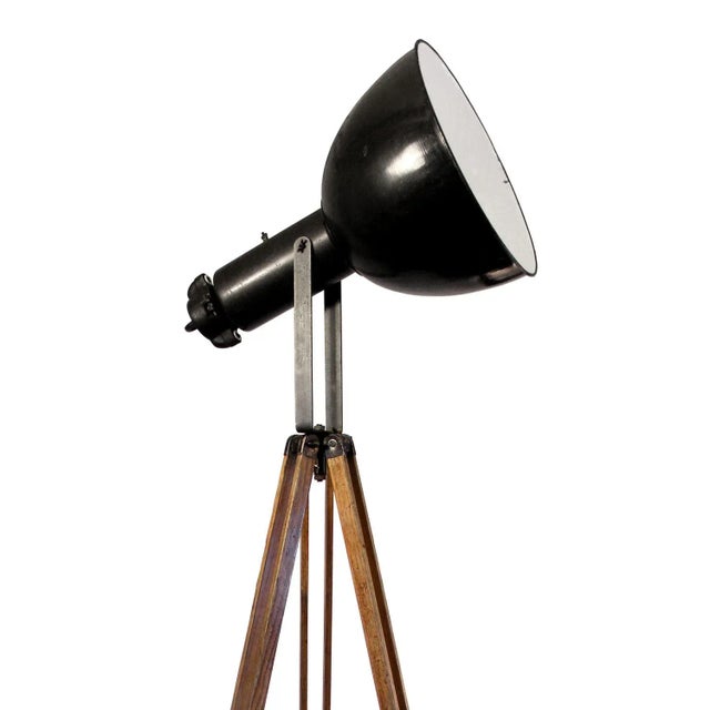 Wooden tripod with dark metal work including industrial spot. Adjustable height and angle, black enamel spot & white...