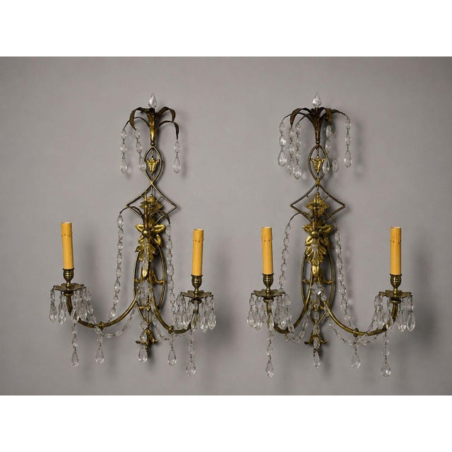 Neoclassical Style, Wall Lights or Sconces, Bronze, Crystal, France, 1950s Elegant pair of French gilt-brass two-arm wall...