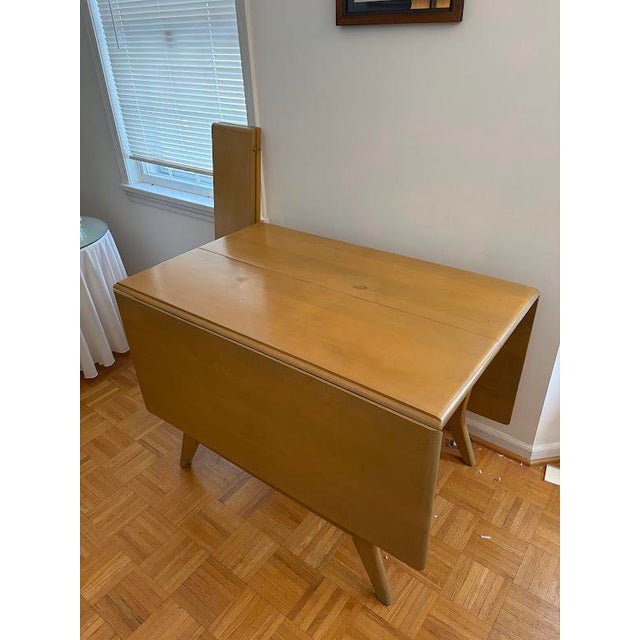 This Heywood-Wakefield Dining Table is made of birch and has a blonde finish called "Platinum" known for its sleek, cool...