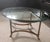 A gorgeous sleek Italian brass and heavy beveled glass oval cocktail table with sweet hooved feet unmarked, but in the...