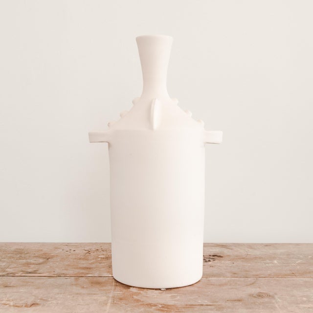 Unglazed white ceramic Elysian vase with handles.