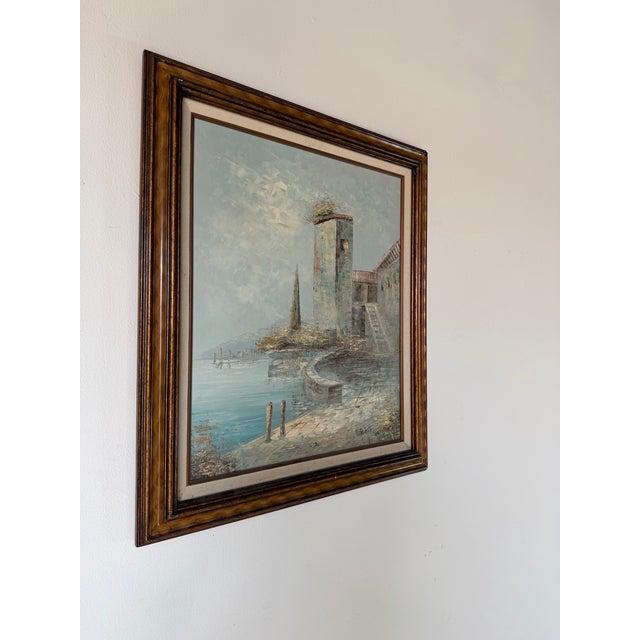 A beautiful vintage oil on canvas by renowned artist Caroline Burnett, depicting a serene European coastal village with...