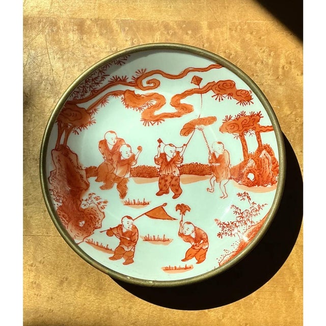 This vintage bowl is a small, jewel-like piece of hand-painted porcelain framed in a polished brass rim. The shallow,...
