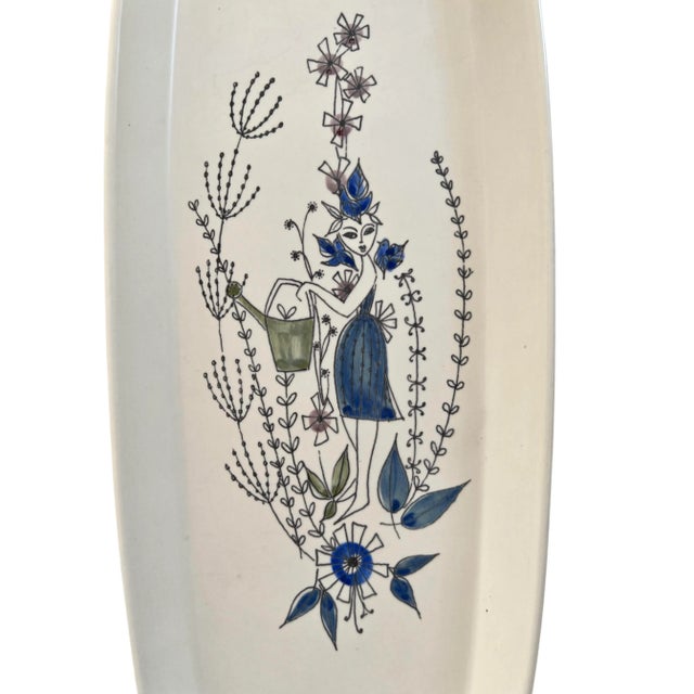 A charming mid-century hand-painted ceramic tray by Stavanger flint, Norway, featuring a whimsical gardener motif rendered...
