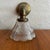 Dating from the early 20th century, this industrial wall sconce features a brass pipe arm with a beautiful time-earned...