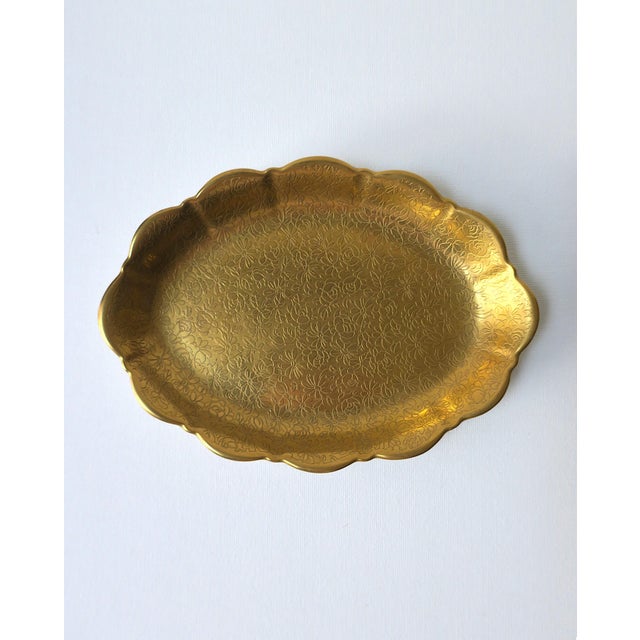 An oval scalloped edge porcelain jewelry dish with a hand-decorated rich gold finish of embossed flower design, circa mid...