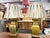 Pair of Brass Mid Century Asian Style Lamps A pair of Asian style mid century brass table lamps on a shaped wood base....