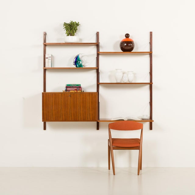 This walnut shelving unit with a desk-shelf was designed by poul cadovius and made by cado in the 1960s. Its simple form...