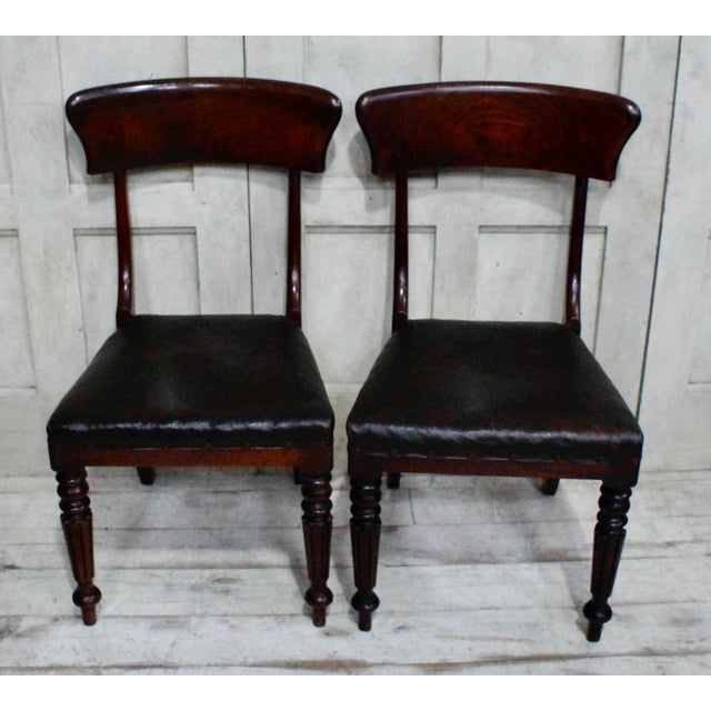 A lovely pair of regency dark oak chairs. Made from mahogany with the original oilcloth seat cover. C1830 antique oilcloth...