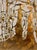 Loosely suggested figures occupy an interior space rendered in lavender and ochre over a ground of gold leaf, the title's...