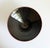 A striking hand-thrown studio pottery bowl featuring a red clay body and dark gray glazed interior, dramatic tapered...