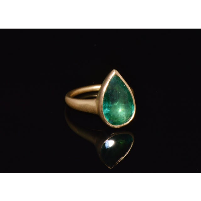 GIA certified natural 5.25CTS 18K solid gold emerald ring. This finely crafted solid 18K yellow gold ring features a...