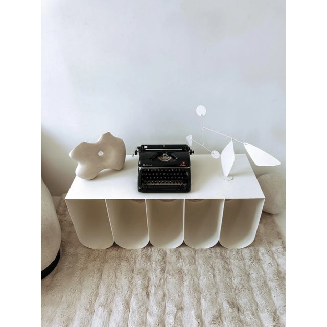 This vintage Optima Elite typewriter is more than just a writing instrument—it’s a striking design piece that instantly...