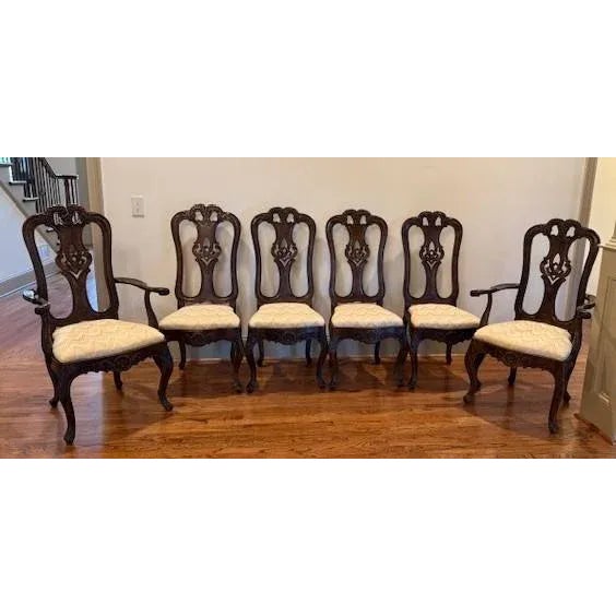 High end and highly carved set of dining chairs in the Italian Rococo taste having two arm and four side. These chairs are...
