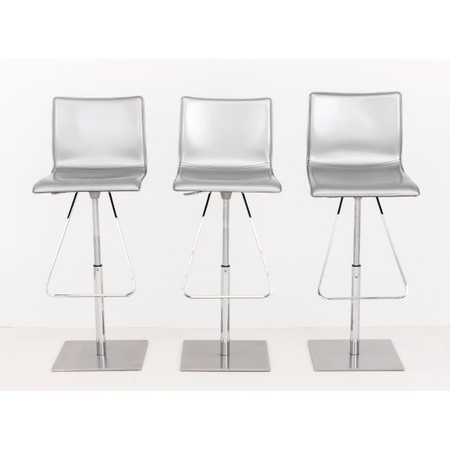 Set of Six Cattelan Italia Adjustable "Toto" Swivel Bar Stools, each with silver-tone leather seat and back above chrome...