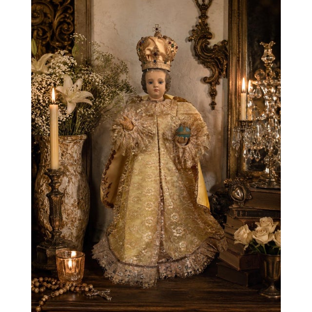 A striking vintage Child Jesus of Prague devotional statue dressed in ornate custom lace garments with satin cape and...