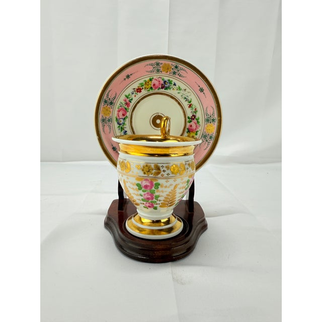 This remarkable 19th-century Old Paris gilt porcelain cup and saucer set embodies the timeless elegance and sophistication...