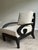Elegant pair of contemporary lounge chairs featuring sculptural scroll arms in a rich ebonized wood finish and newly...