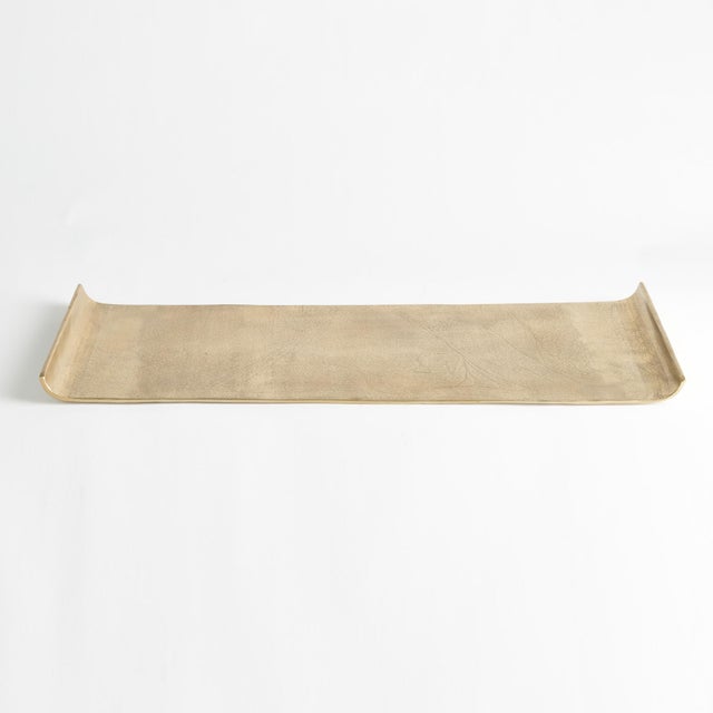 This overscale elongated cast aluminum tray is a beautiful way to display a styled vignette with books and vase or with a...