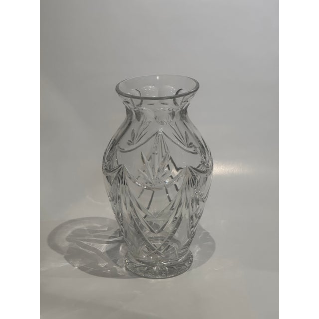 Impressive large Waterford cut crystal urn-form vase featuring dramatic sweeping fan cuts, a rounded bulbous body, and a...