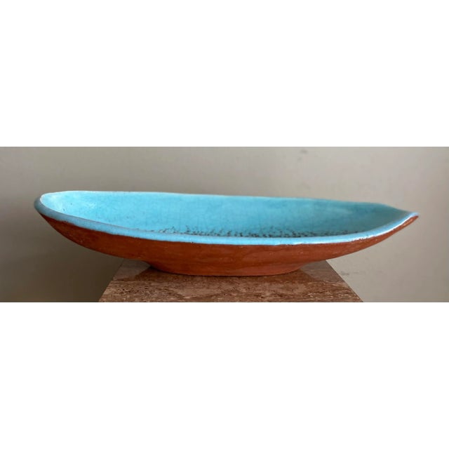 Large mid-century modern 1950s pottery bowl with fish motif. Measures 17” in length, x width of about 8” and depth of 3”....