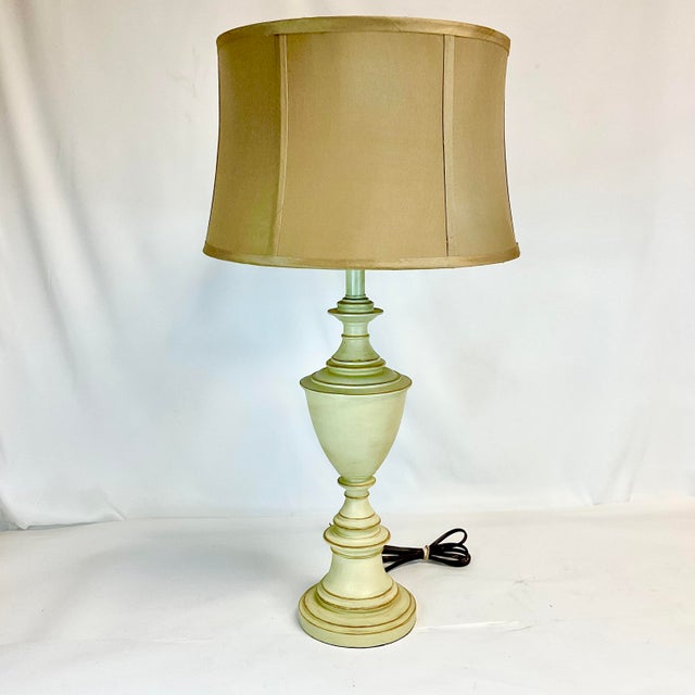This is a lovely metal tole table lamp in the French Empire Neoclassical style. We love the simplicity of the color...