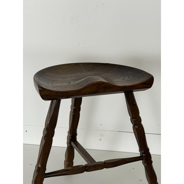 This tripod stool is Danish in origin and dates from the 1960s. The solid oak seat is carved with a saddle profile,...
