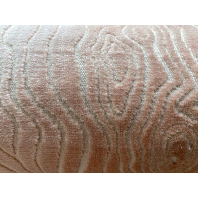 This bolster pillow features a soft, velvety texture in a blush pink tone with an elegant, embossed woodgrain pattern. The...