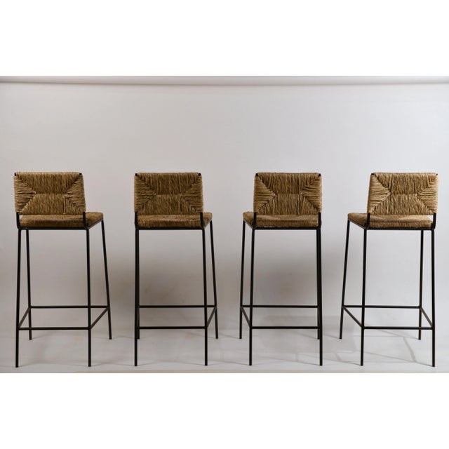 Set of 4 'Campagne' steel and rush counter stools by Design Frères. Chic combination of slender but sturdy powder coated...