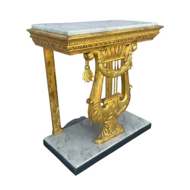 Swedish Gustavian Console Table. This table is crafted in carved giltwood, and crowned with a white marble top. The piece...