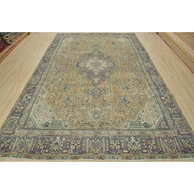 An authentic vintage traditional Tabriz rug hand-knotted with fine wool and natural dyes. This beautiful oriental rug...