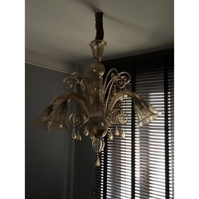 This magnificent and elegant Murano blown glass chandelier has 8 arms, 8 lights and 8 decorative arms. The bulbholders...