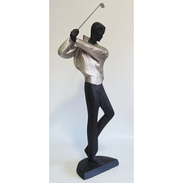 A tall decorative sculpture of a golfer in midswing by Alexsander Danel. It stands 33.5" tall and approximately 16" across...