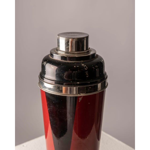 An elegant Art Deco cocktail shaker, made around 1940 and designed in the decorative style associated with Jean Dunand and...