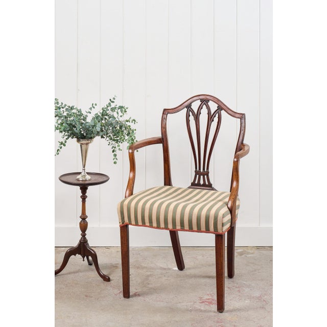 This Georgian shield-back armchair is crafted from rich Cuban mahogany and features a back shield with openwork splats...