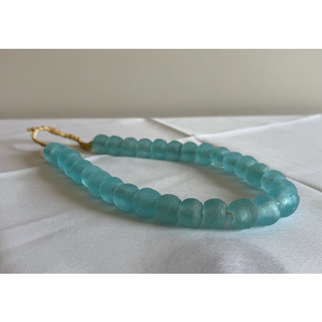 Vintage Aqua Recycled Glass Beads – Strand Bring a touch of artisanal charm to your décor with this beautiful strand of...