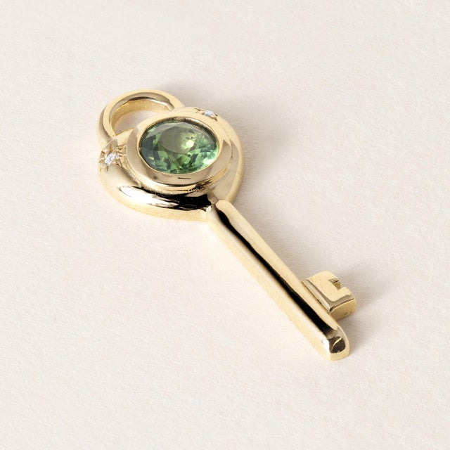 This is a vintage inspired key pendant using a recycled gemstone Details: 0.57ct Tsavorite garnet Bright green and very...
