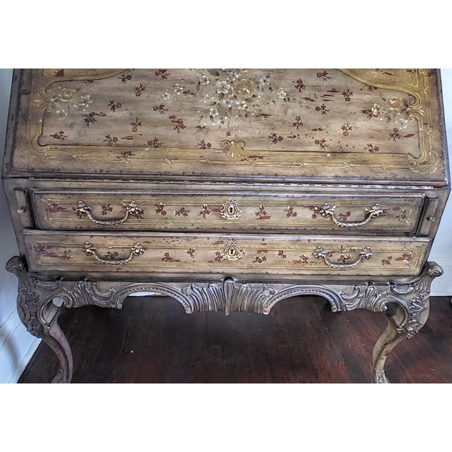 A richly decorative Lillian August slant-front secretary desk combining French Provincial and Rococo Revival influences...