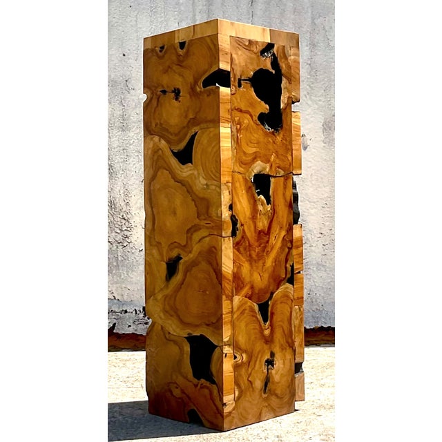 An impressive vintage slab burl single wood pedestal showcasing the dramatic natural movement of burl grain. The tall...