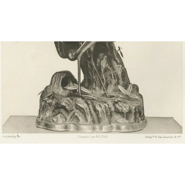 Title: elegant cranes on ornamental base – plate xiv from section vi of g. A. Audsley’s decorative art series : plate xiv...