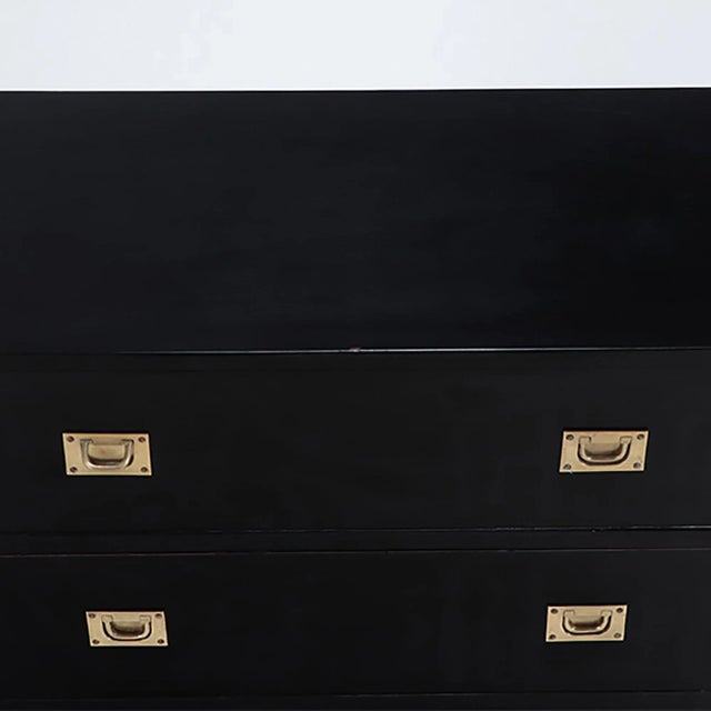 An ebonized mahogany three drawers brass mounted campaign style chest . Circa 1940