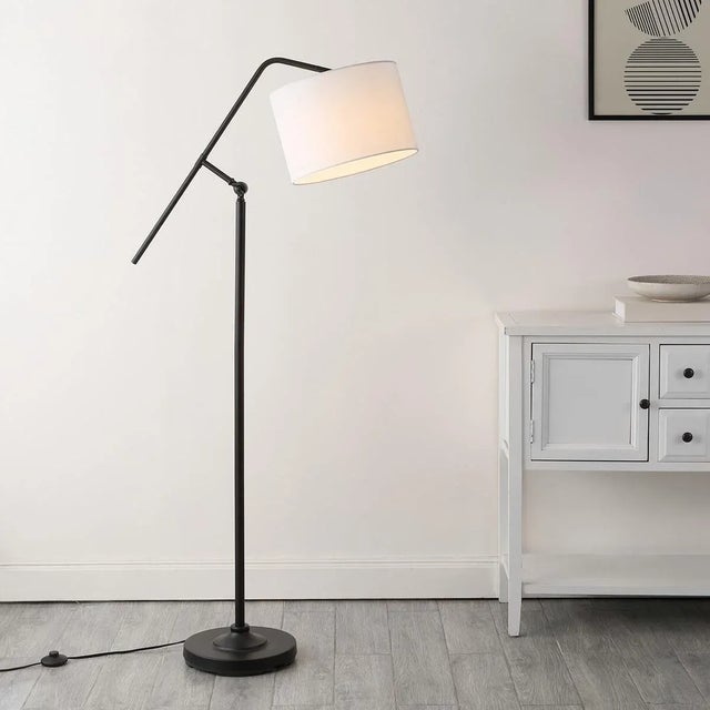 Illuminate your space with the stunning Newbrook floor lamp. Standing at 62.5 inches, this sleek black iron design...