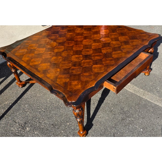 This Georgian Style Parquetry Top Coffee Table with Scalloped Edge and X-Form Stretcher from the late 21st Century is a...