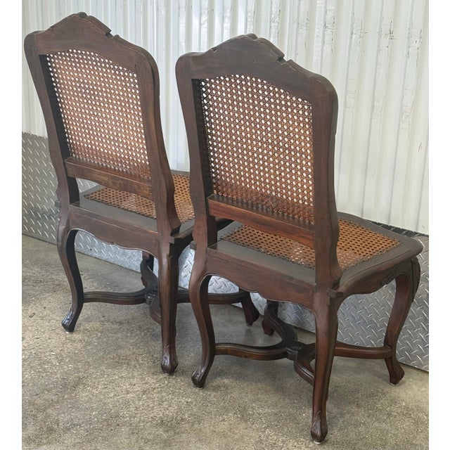 Gorgeous pair of vintage French chairs circa 1920-30s. The chair is constructed from a dark, rich-toned wood, possibly...