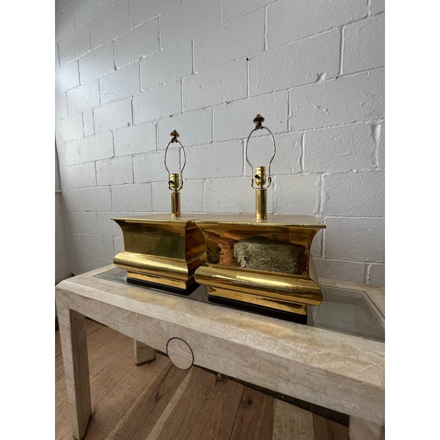 A striking pair of vintage solid brass table lamps showcasing a bold sculptural waterfall or Ming form with glamorous...