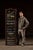 This tall turn-of-the-century reverse-painted glass advertising sign features richly rendered gold-leaf lettering...