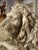 This is a 19th century French reconstituted stone lion statue lying down on a rectangular base. The sculptor who did the...