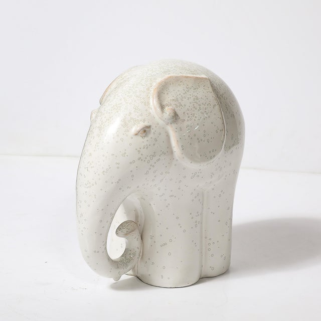 This striking Mid-Century Modernist elephant sculpture, crafted in off-white glazed terra cotta, embodies the minimalist...