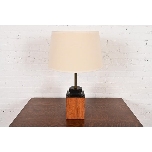 A unique Mid-Century Modern teak and brass table lamp In the manner of Milo Baughman USA, Circa 1960s Measures: 17.75"W x...
