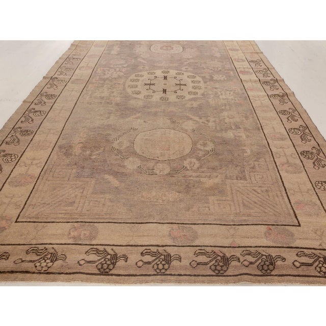 Midcentury Samarkand handmade wool rug in beige and brown. Size: 3'9" × 6'10" (114 × 208 cm). Although its name translates...
